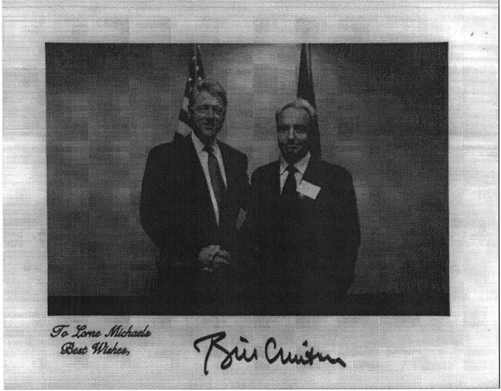 Holiday card from Bill Clinton to Lorne Michaels, featuring a picture of the two men shaking hands.